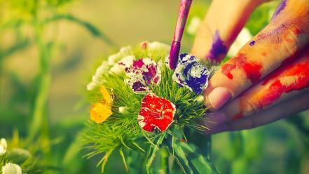 Multicolor flowers leaves hands paint brushes blurred background wallpaper