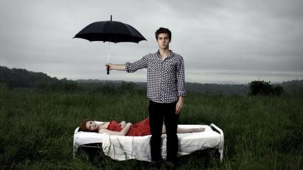 Men couple red dress lying down umbrellas wallpaper