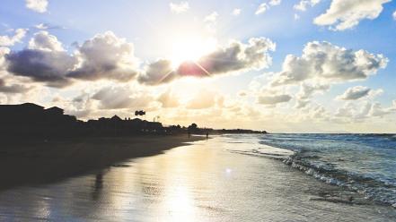 Beach sand waves wet people foam sky wallpaper