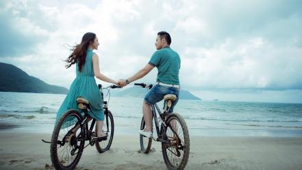 Coast bicycles men holding hands sea beach wallpaper