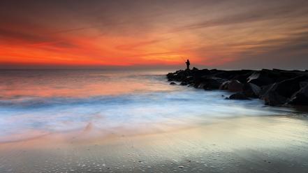 Sunset beach silhouette rocks fishing seascapes new jersey wallpaper