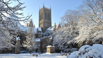 Snow trees bench church statues wallpaper