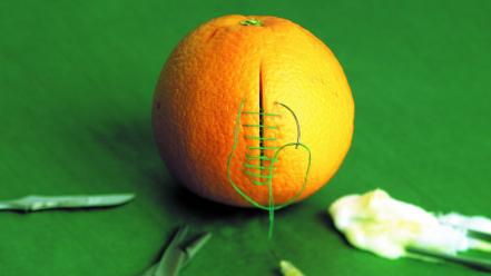 Orange funny medical stitch cutting green background wallpaper