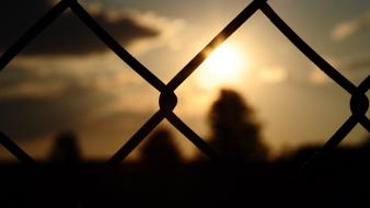 Blurred background chain link fence fences silhouettes sunset wallpaper