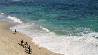 Beach sand waves people foam surfers sea wallpaper