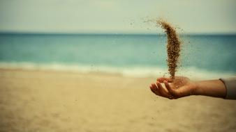 Sand flying hands beach wallpaper