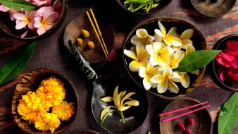 Flowers leaves bowls marigold plumeria herbs