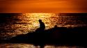 Sunset nature silhouettes rocks lonely sitting sea beach wallpaper